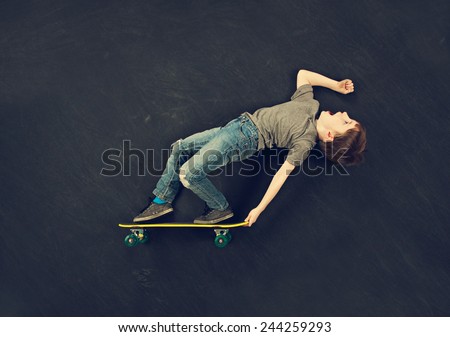 Young boy performing skateboard trick
