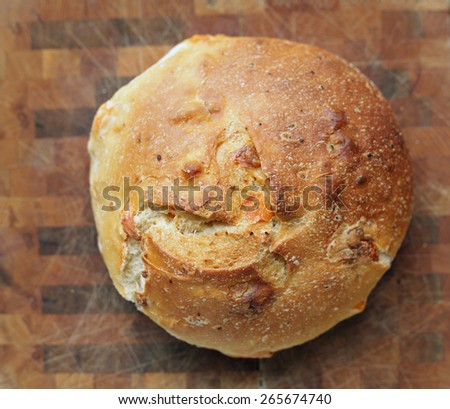Fresh baked loaf of cheese garlic bread on a wood background on a wood background