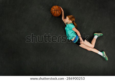 Girl dunking basketball