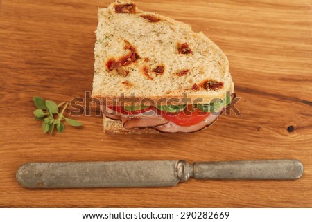 Sandwich on a wood cutting board.