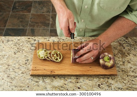 Bell peppers being prepared on a wood cutting board