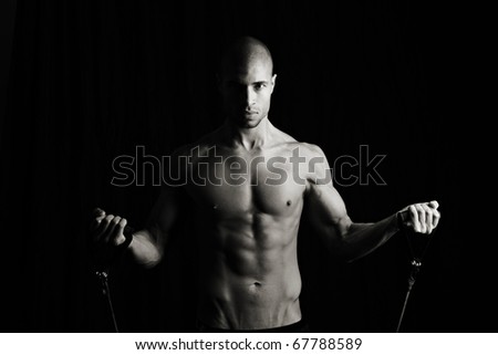Fitness man with resistance bands, Low key