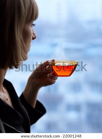 Young woman with a cup of hot tea