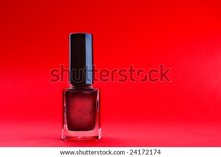 Purple nail polish on the red background