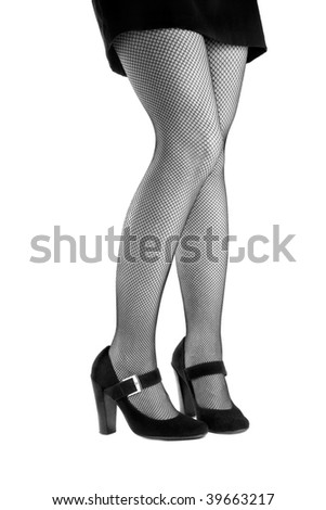 Woman\'s legs in high heels and mesh stockings isolated on the white background shot in black and white