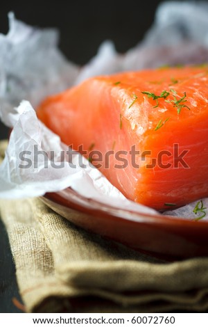 Piece of smoked salmon with dill on the plate,shallow focus