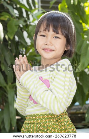 Thai little cute girl in action - tradition dress