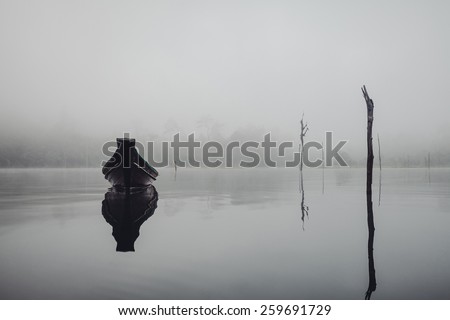 boat on the lake in the fog