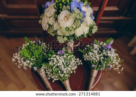 Wedding bouquets of flowers and greenery on a vintage wooden chair