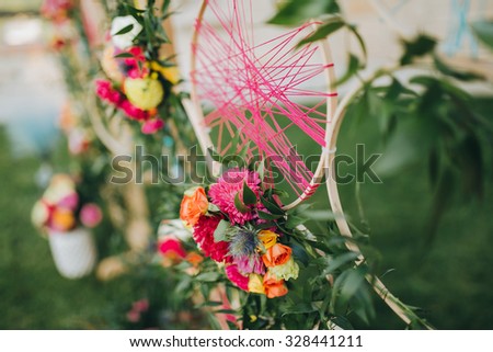 Area decorated wedding flower arrangements, stained carpet and the hoop with colored thread