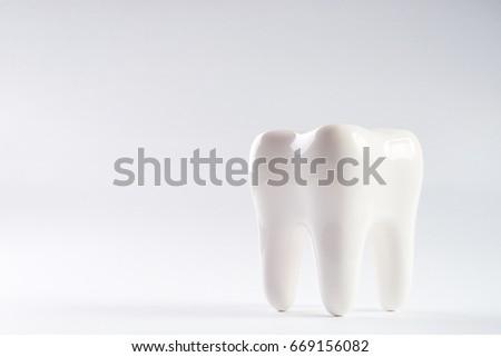 White healthy Tooth isolated on white background with copy space. Oral dental hygiene. Teeth Whitening. Dental health Concept. Oral Care, teeth restoration. Yellow and white teeth.