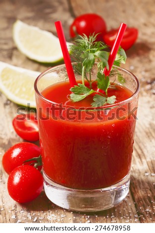 Red cocktail with tomato juice, lime and salt, selective focus