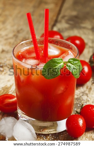 Red cocktail with tomato juice, ice and salt, selective focus