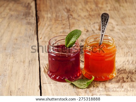 Two kinds of home-made jam from strawberry and apricot, selective focus