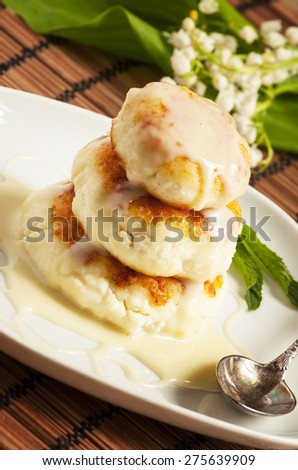 Homemade cottage cheese pancakes with white sauce, selective focus