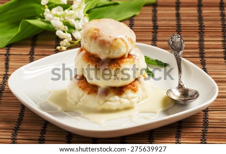 Homemade cottage cheese pancakes with white sauce, selective focus