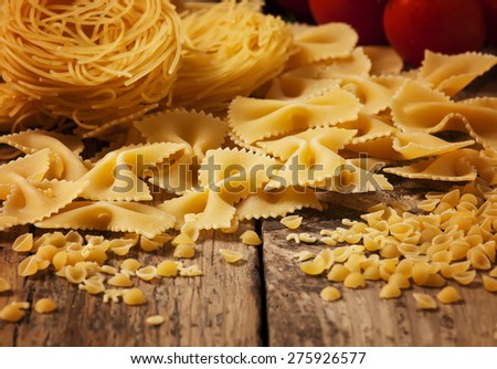 Variety of pasta on a wooden table, selective focus