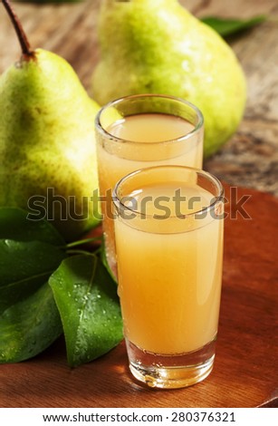Pear fresh juice and pear on a wooden table, selective focus