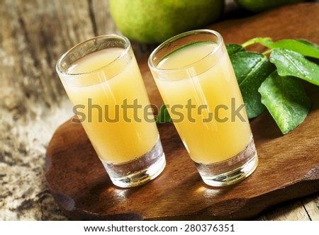 Pear fresh juice and pear on a wooden table, selective focus
