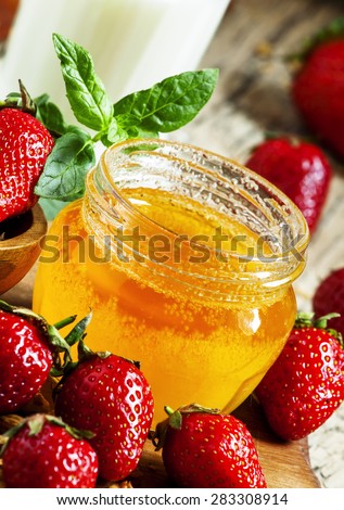 Jar of honey, strawberries, muesli, milk bottle, healthy eating concept, selective focus