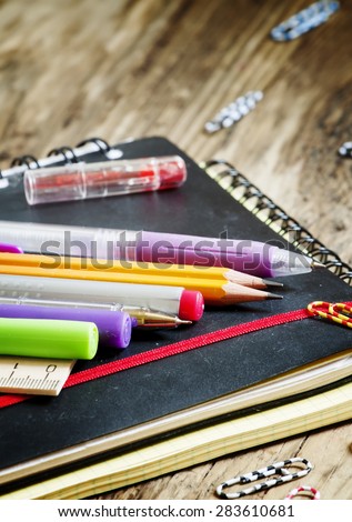 School supplies and office stationery: pens, pencils, notebooks, paper clips, selective focus
