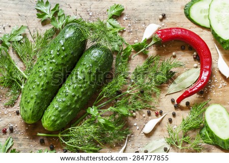 Preparing pickled cucumbers with spices and herbs, top view, selective focus