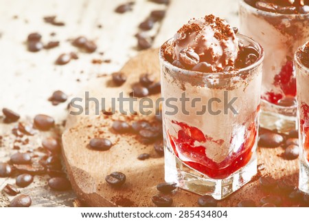 Delicious coffee and chocolate ice cream with strawberries, decorated with coffee beans, selective focus
