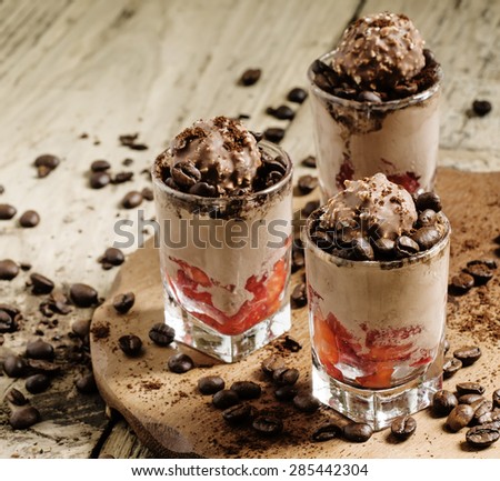 Delicious coffee and chocolate ice cream with strawberries, decorated with coffee beans, selective focus
