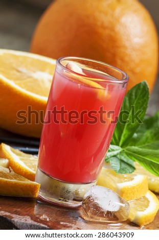 Freshly squeezed juice from red orange with pulp, selective focus