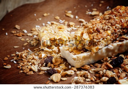 Bar muesli and spilled cereal with raisins, selective focus