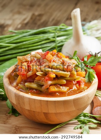 Traditional Caucasian Georgian lobio of green beans with vegetables and tomato, selective focus