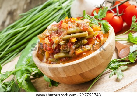 Traditional Caucasian Georgian lobio of green beans with vegetables and tomato, selective focus