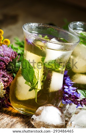 Herbal flower iced tea with ice in Islamic glasses, selective focus
