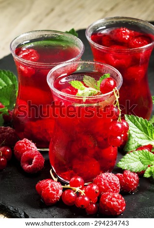 Red drink of raspberry and red currant and mint, selective focus