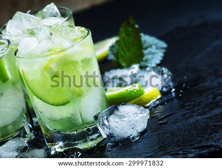Lemon-lime green drink with crushed ice on a dark background, selective focus