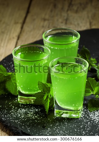 Green cocktail with rum, mint, soda and sugar, selective focus