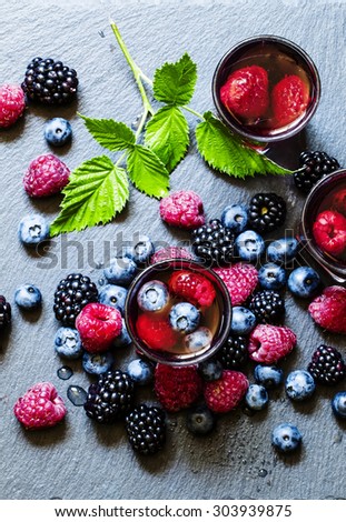 Juice of wild berries on a dark background, top view, selective focus