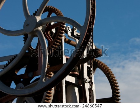 Cogs, wheels and chains against a blue sky