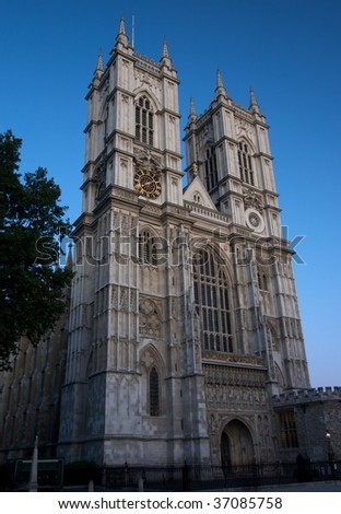Westminster Abbey\'s west gothic facade against a blue twilight sky