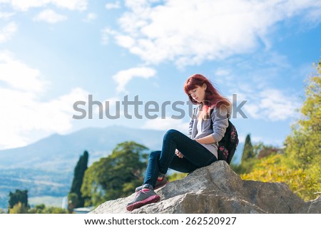 girl with a backpack on top of Mount meditation