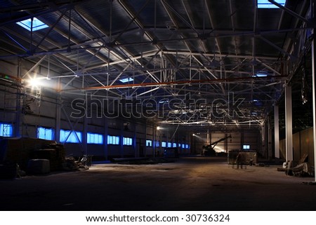 big empty hangar with white metal roof