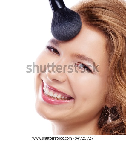 Attractive young woman smiled applying makeup powder on white background, caucasian woman makeup