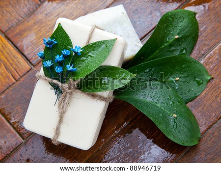 Homemade soap with blue lavender flowers on the floor