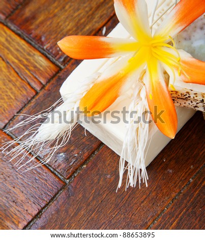 Homemade soap with yellow flower on the floor