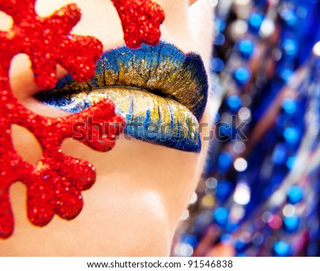 Glamour Blue Gold gloss lips moving up on bright blue background, shallow focus