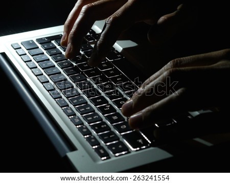 Cybercrime - two Hands on keyboard in the dark