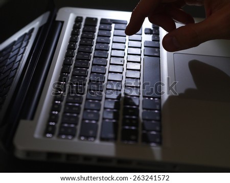 cybercrime - top view one hand on keyboard