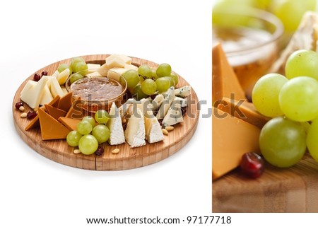 Cheese and fruit platter isolated on white.