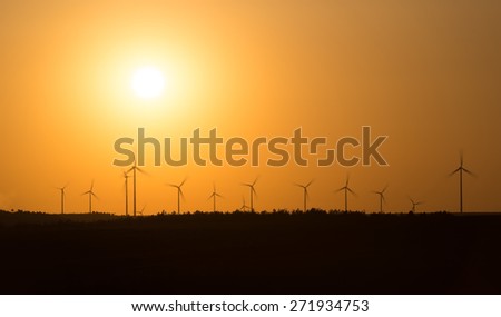 the movement of wind turbines at sunset 2