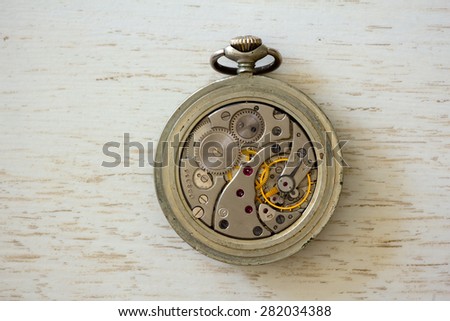 vintage clock mechanism on wooden board